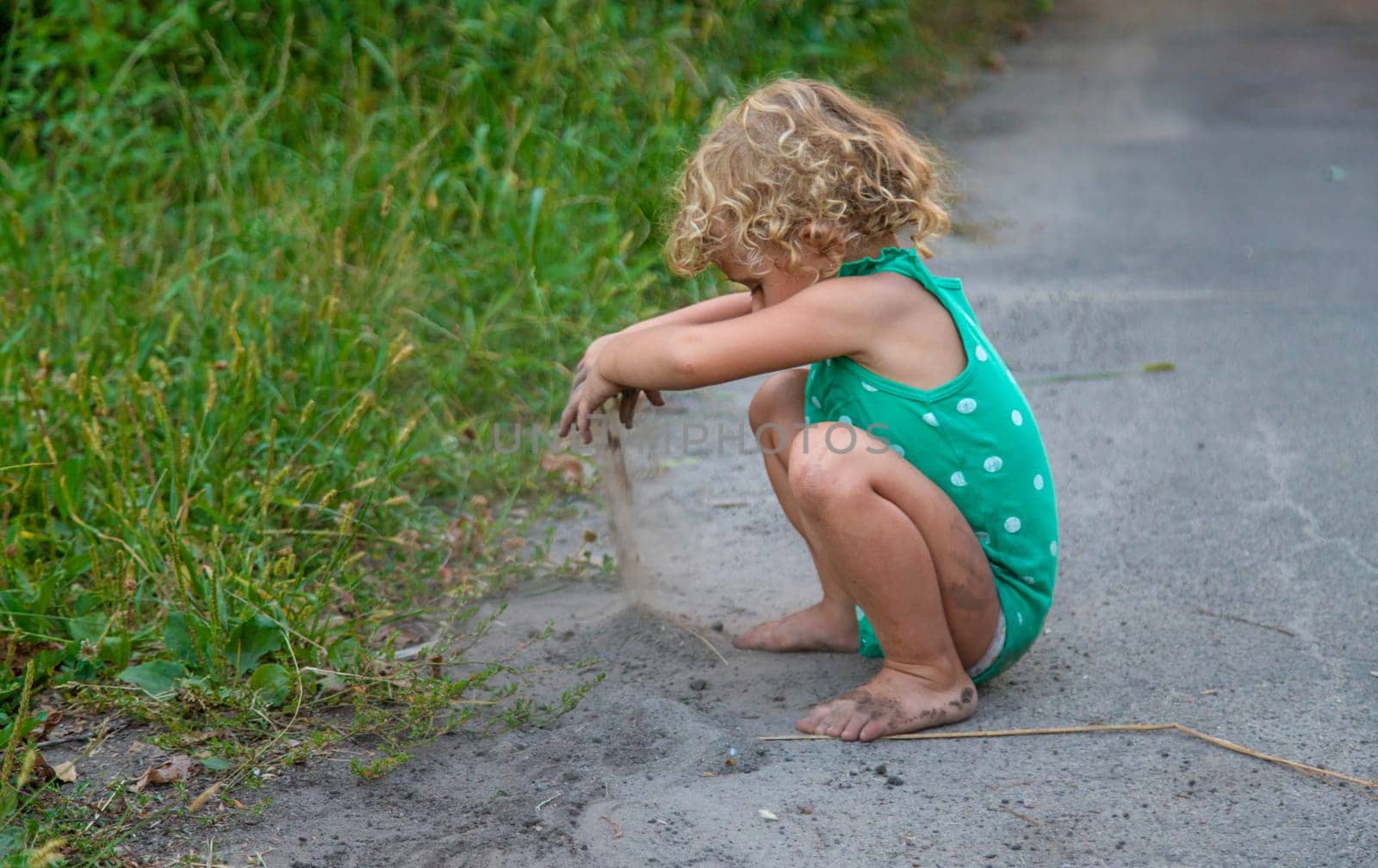 Children play with sand on the street. Selective focus. Kids.