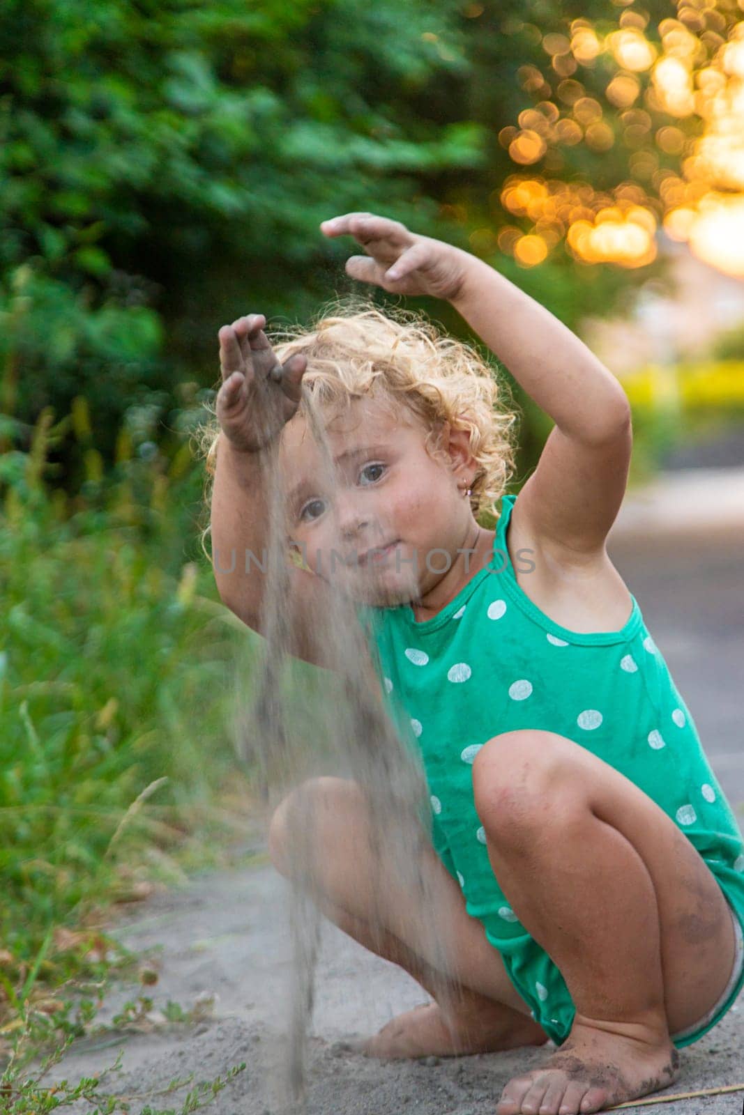 Children play with sand on the street. Selective focus. Kids.