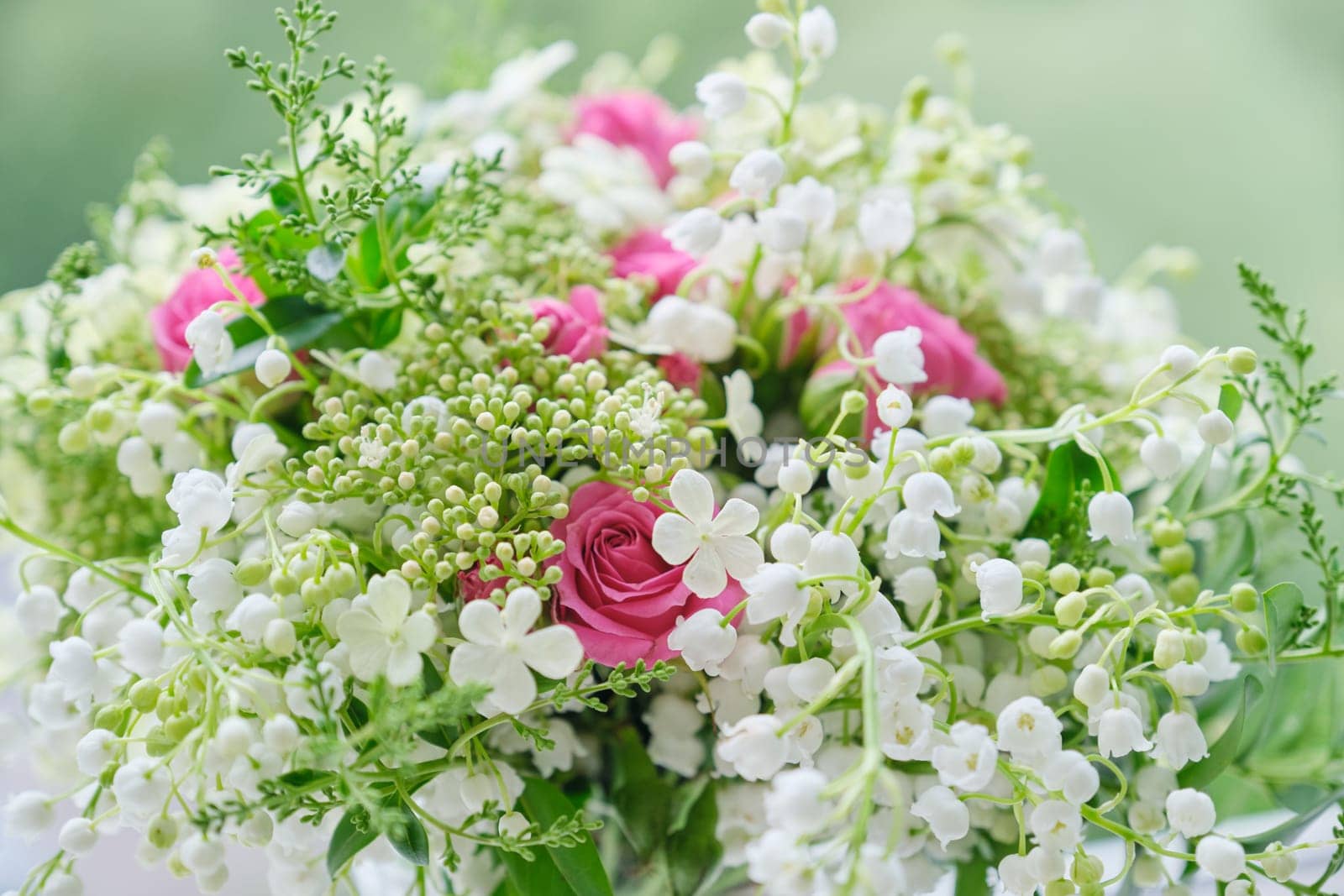Springtime, spring fresh bouquet of lilies of the valley, pink roses, blooming viburnum. Texture, background