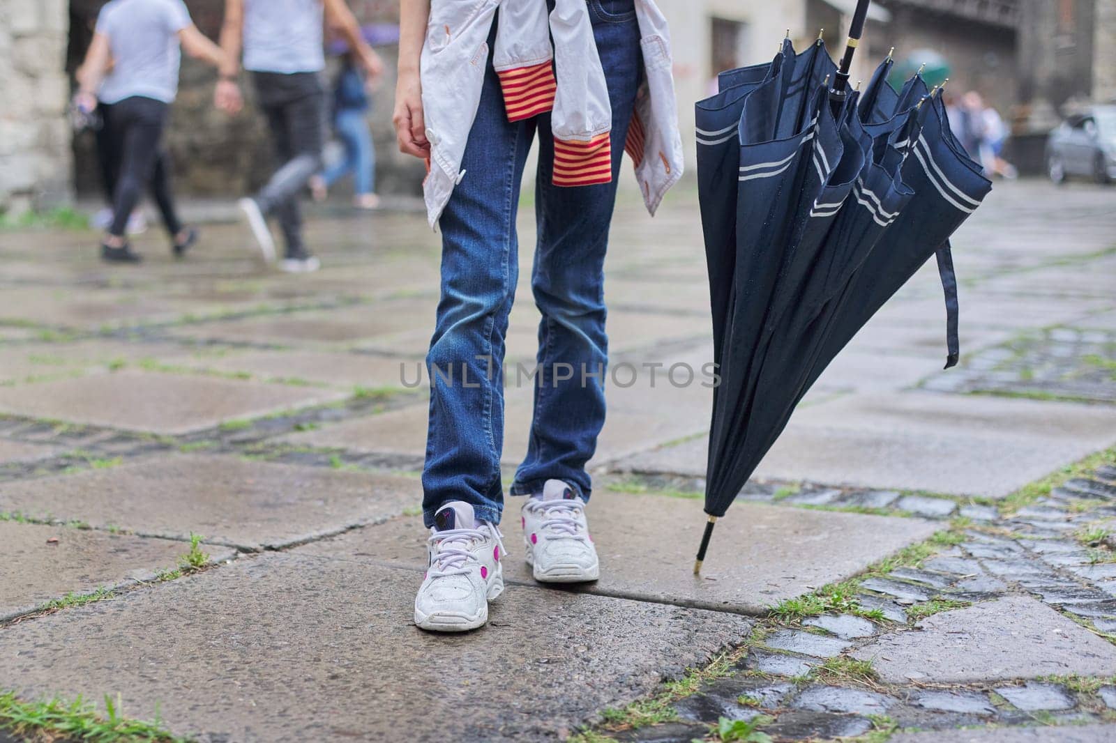 Rainy weather, legs of girl with an umbrella by VH-studio