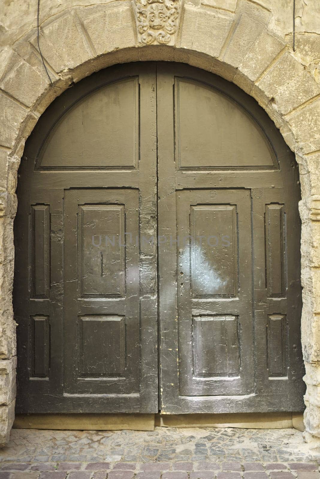 Old vintage wooden facade decorative brown door.