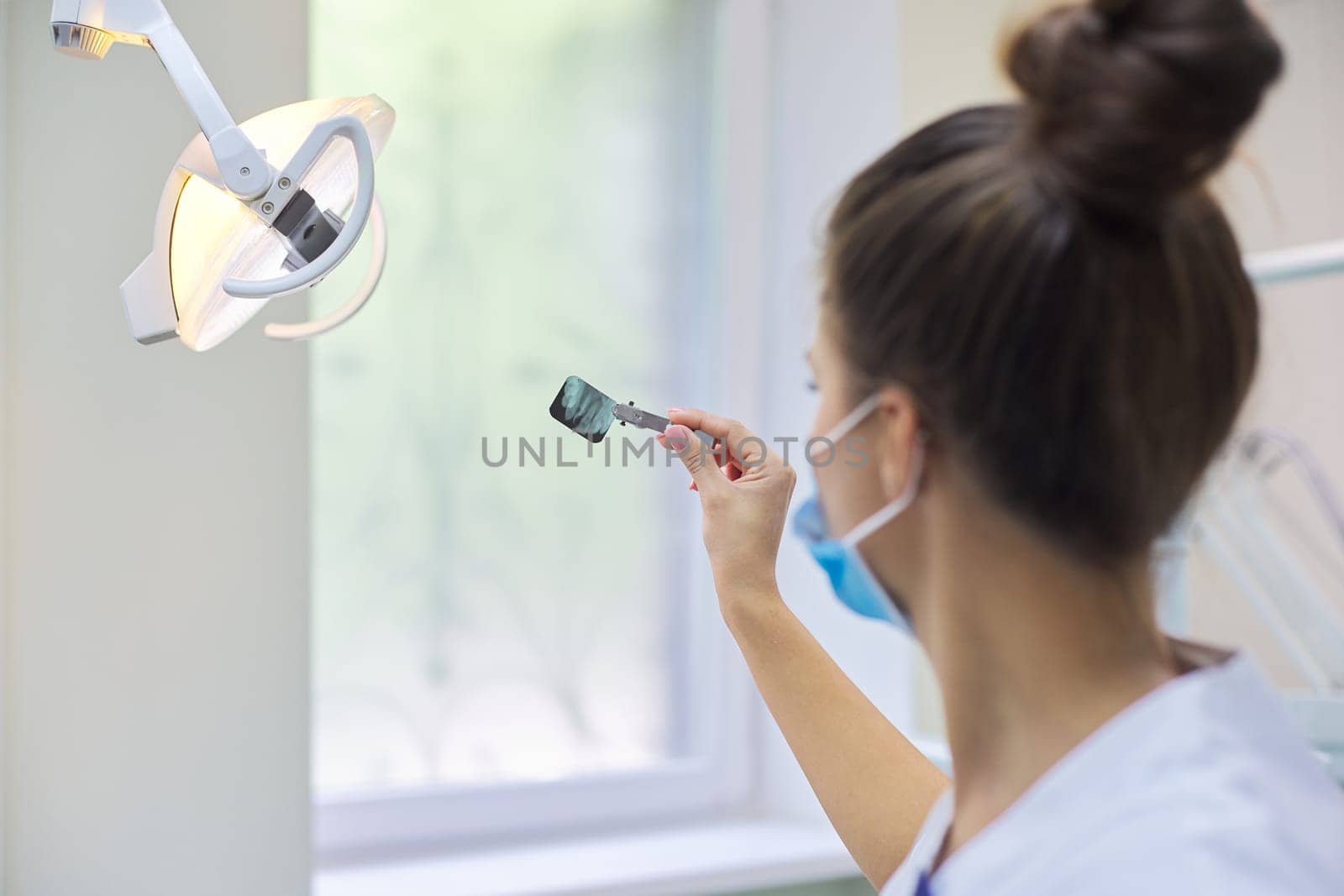 Close up dental x-ray shot of teeth in the hands of dentist doctor by VH-studio