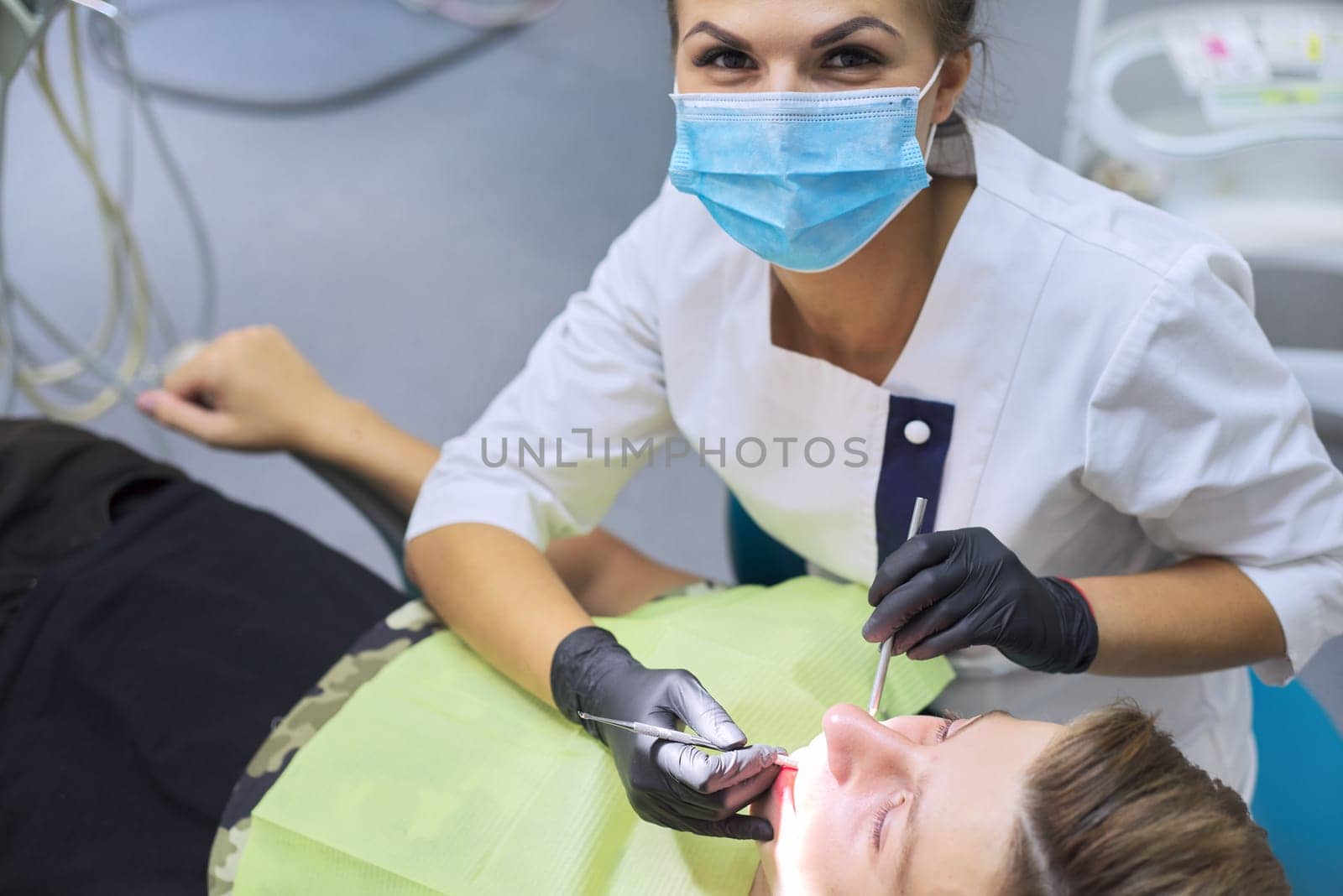 Close up dental treatment procedure in dental office. Dentistry, healthy teeth, medicine and healthcare concept