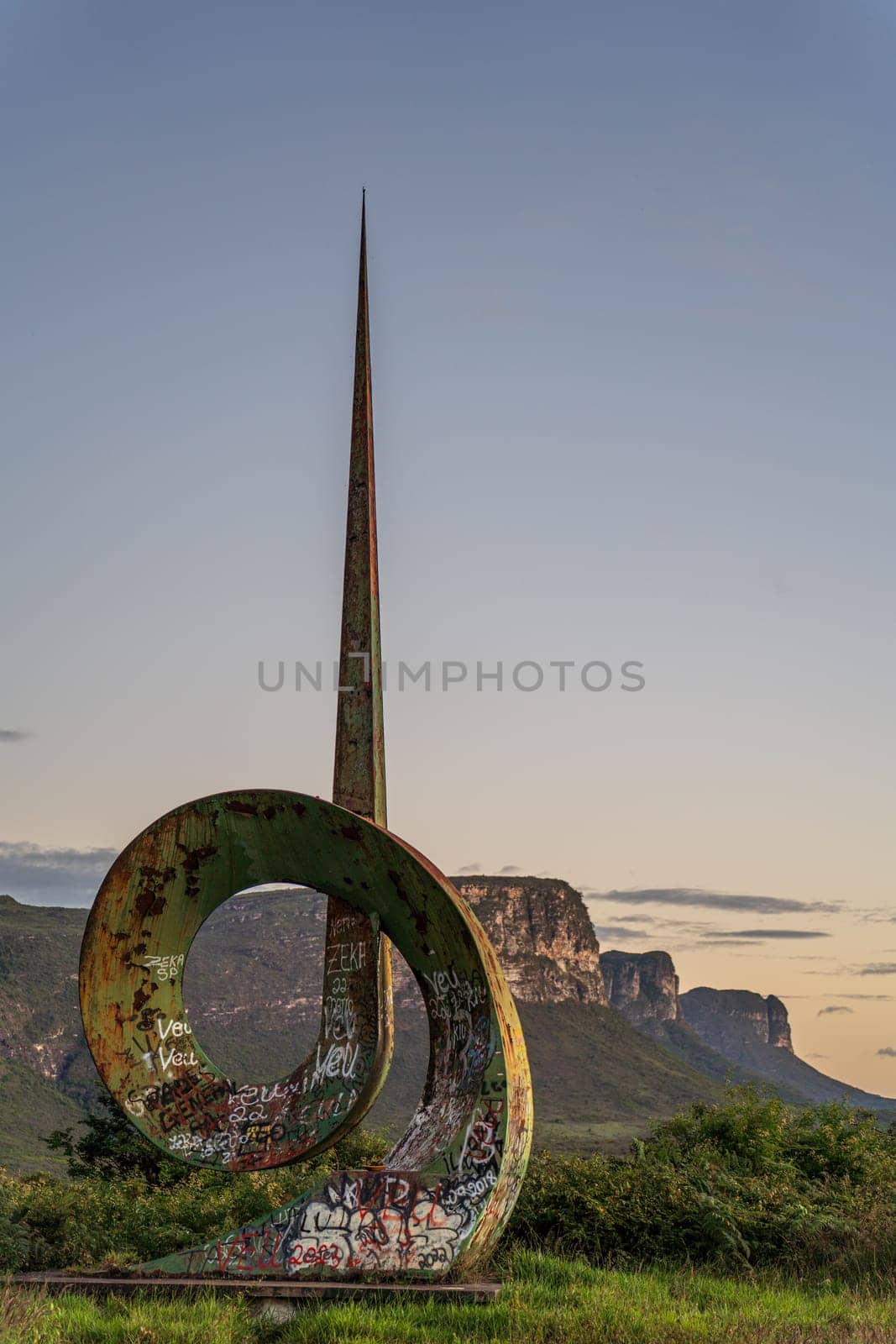 Abstract Sculpture with Graffiti Against a Mountainous Skyline by FerradalFCG