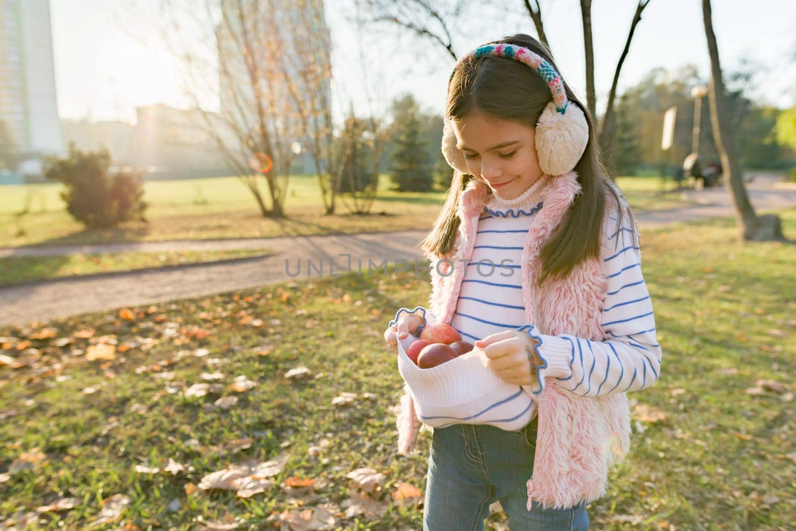 Harvesting, little beautiful girl with apples in autumn park by VH-studio