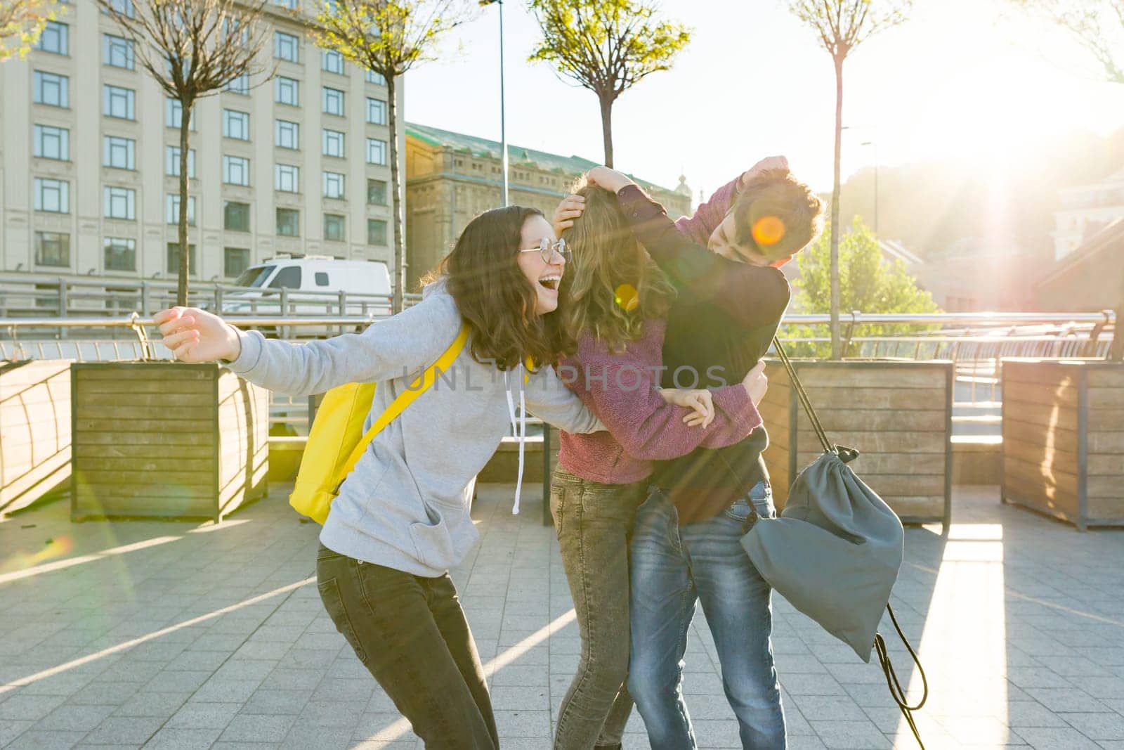 Friends teenagers students with school backpacks, having fun on the way from school. by VH-studio