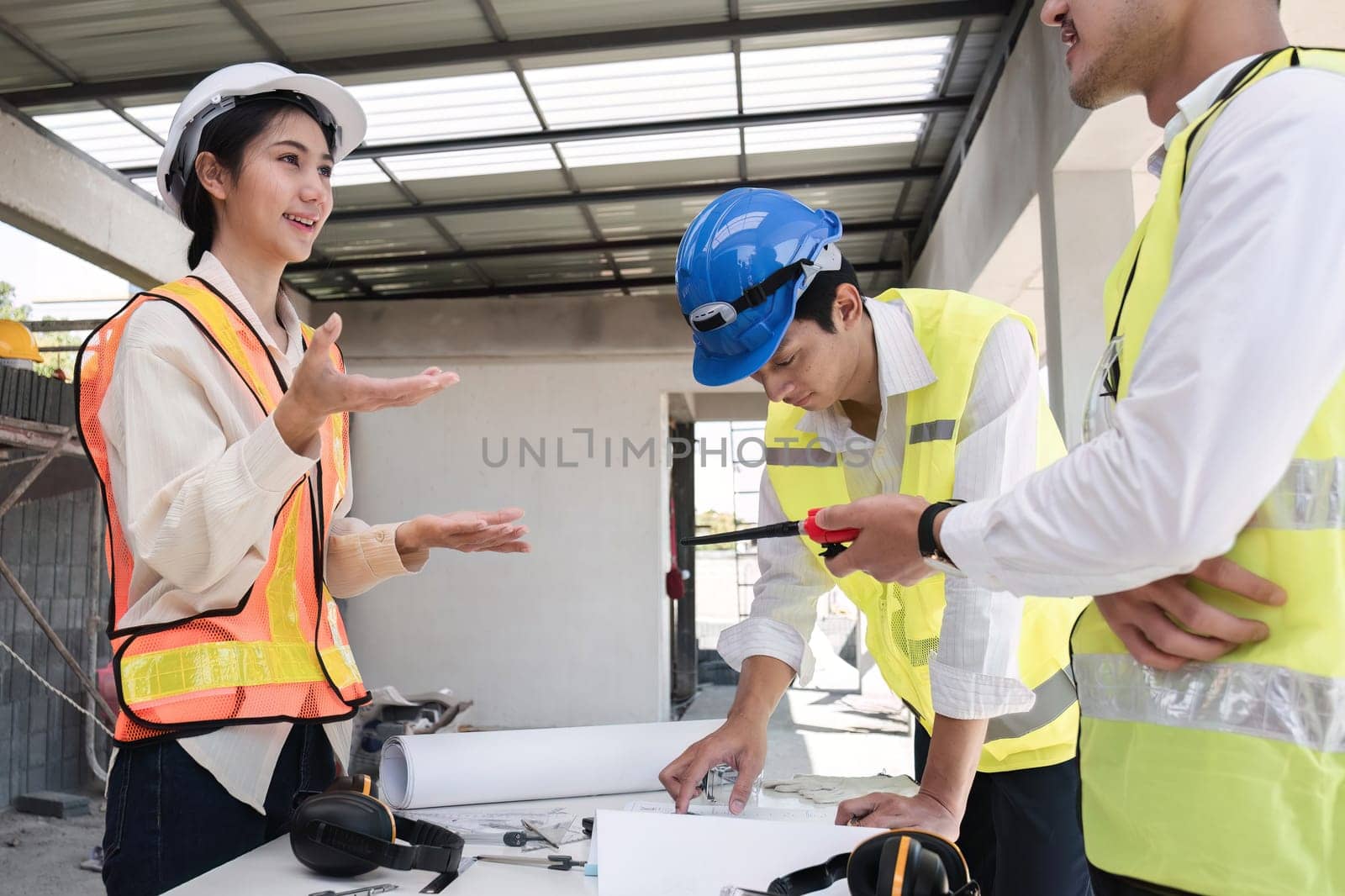 Civil engineering team meets to plan work on construction project in the construction area Foreman, industrial project manager, engineer working as a team Professional team in Asian industry.