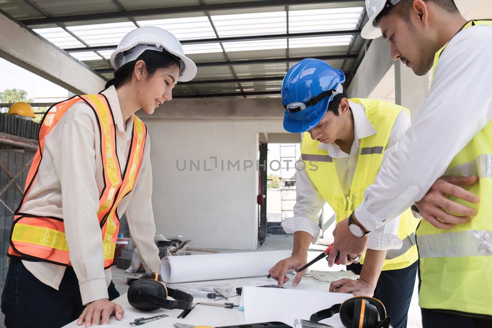 Civil engineering team meets to plan work on construction project in the construction area Foreman, industrial project manager, engineer working as a team Professional team in Asian industry.