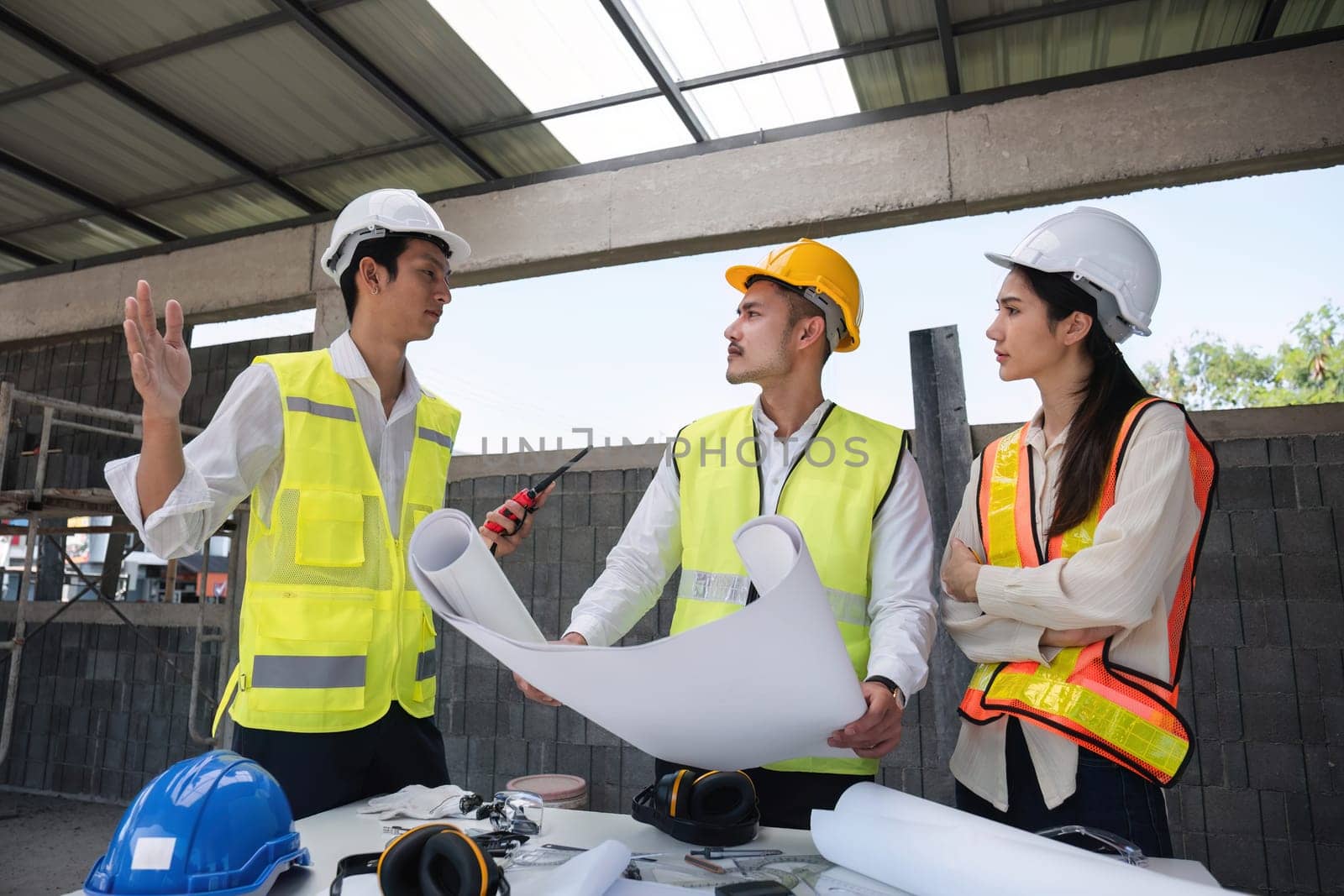 Civil engineering team meets to plan work on construction project in the construction area Foreman, industrial project manager, engineer working as a team Professional team in Asian industry by wichayada