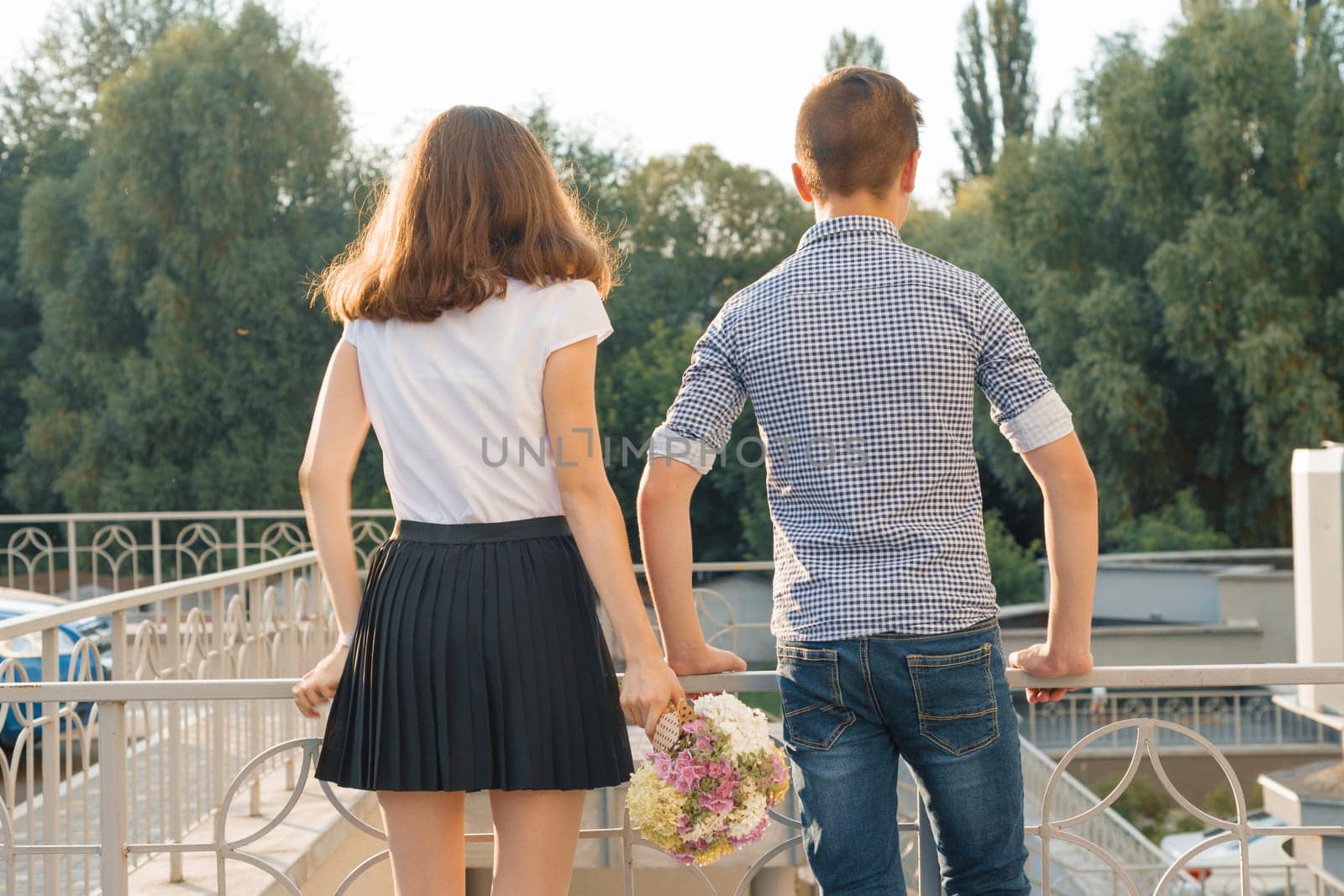 Teen youth couple boy and girl standing back by VH-studio