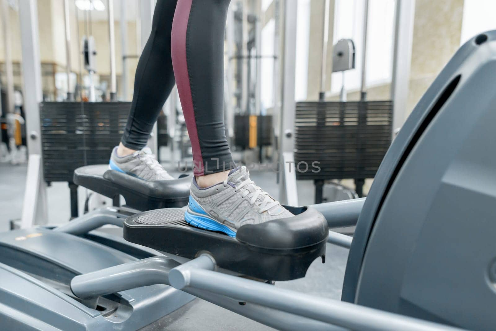 Closeup of woman feet running on treadmill in gym. Fitness, sport, training, people concept