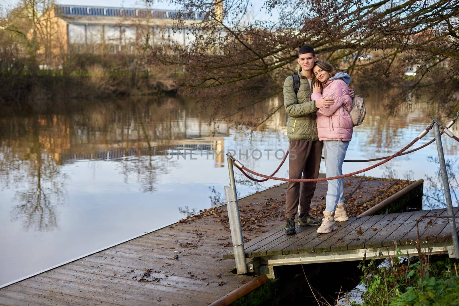 Embracing Moments: Beautiful 35-Year-Old Mother and 17-Year-Old Son in Winter or Autumn Park by Neckar River, Bietigheim-Bissingen, Germany by Andrii_Ko