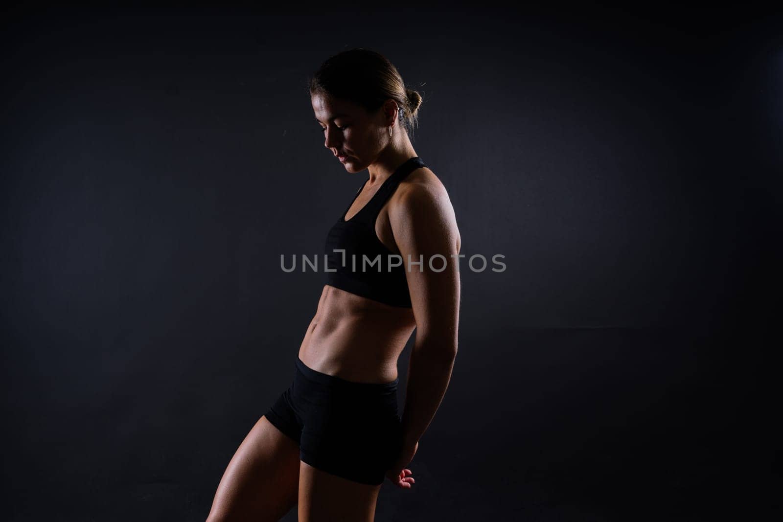 Close up of woman back with muscles after workout. Female bodybuilder with perfect biceps