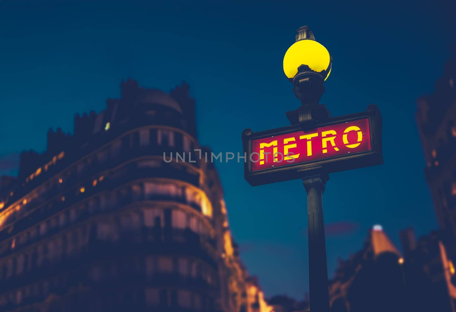 Metro Sign In A Residential Area Of Paris, France At Night