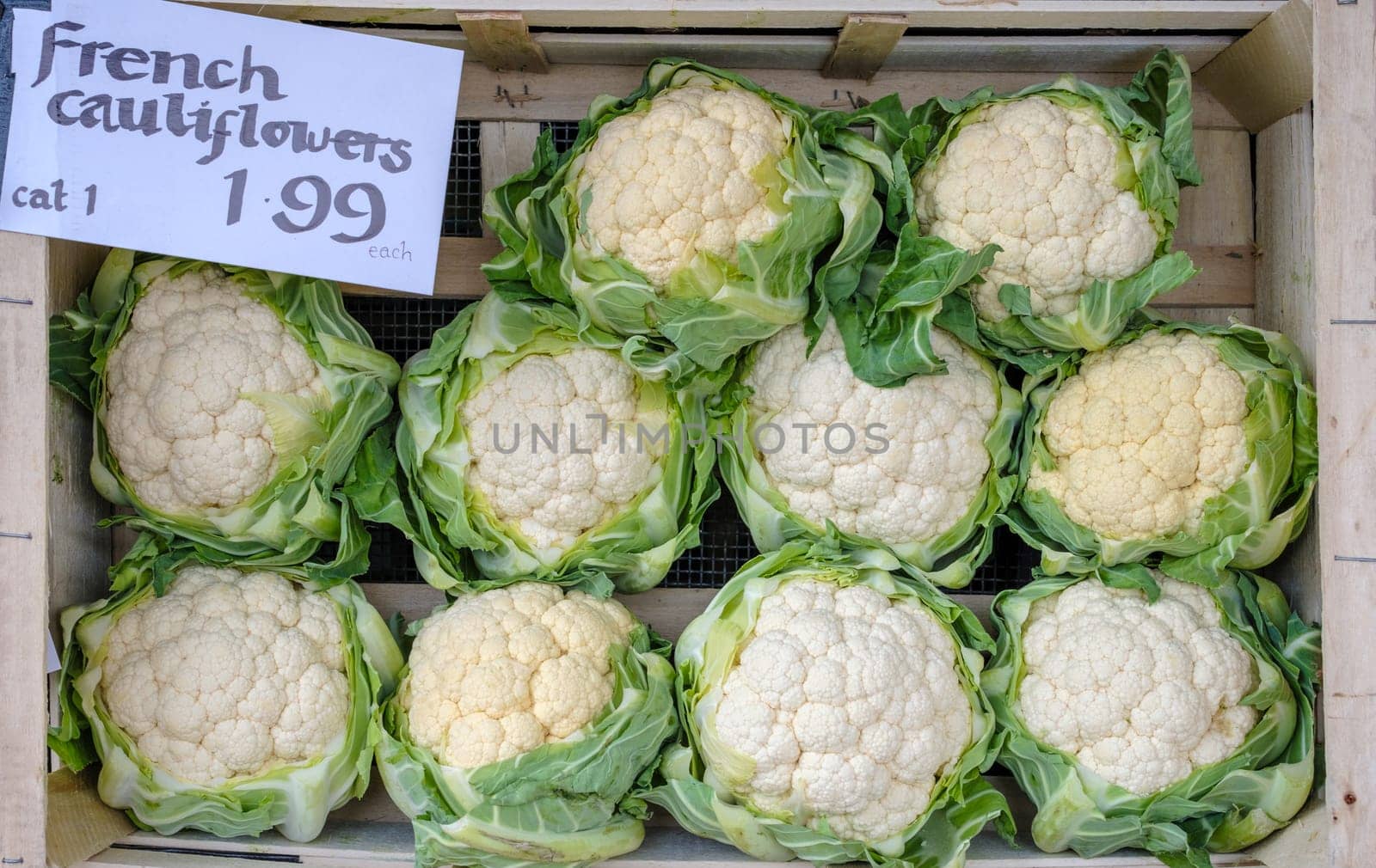 A Basket Of Fresh Organic Cauliflowers At A Market Stall
