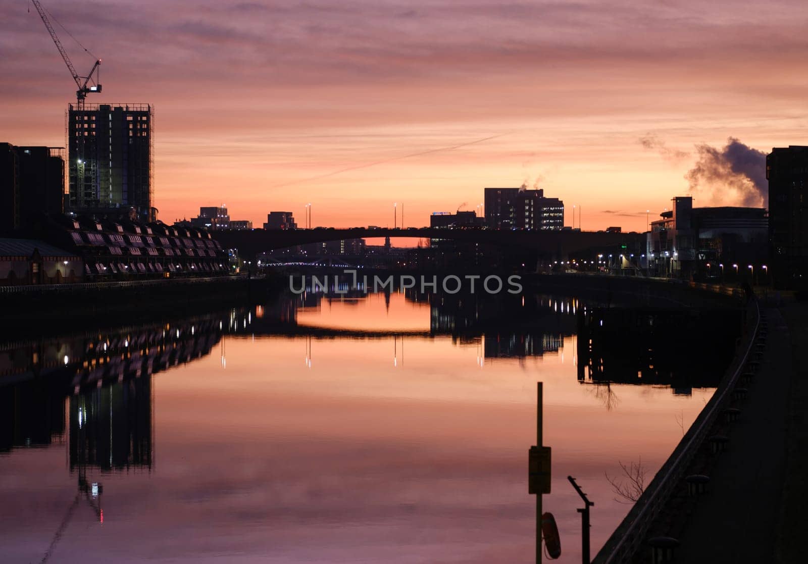The Glasgow Skyline Reflected In The River Clyde During A Beautiful Sunrise