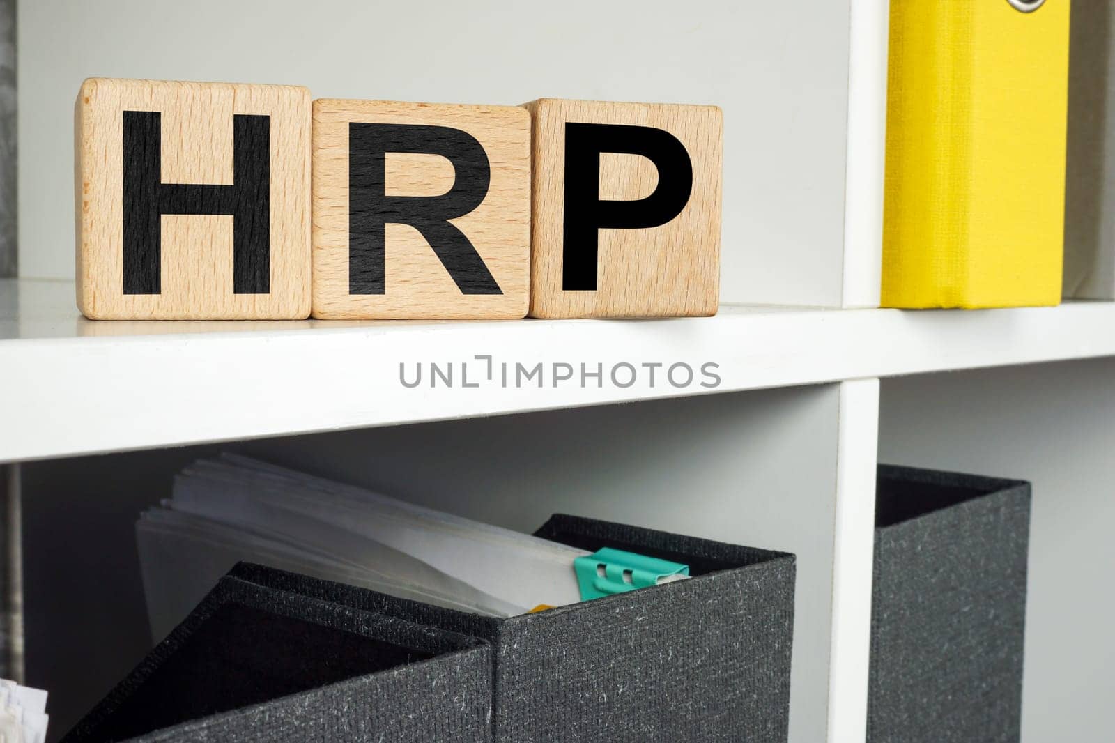 HRP human resource planning concept. Wooden cubes lie on an office shelf. by designer491