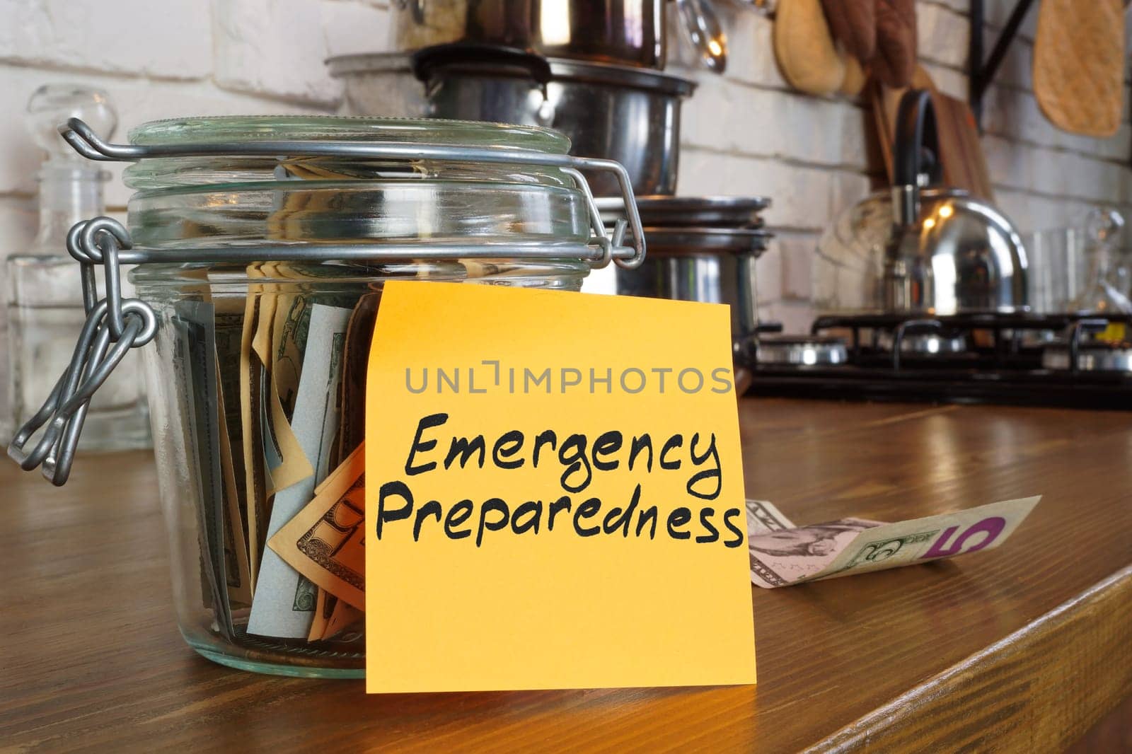 Jar with savings and label emergency preparedness. by designer491