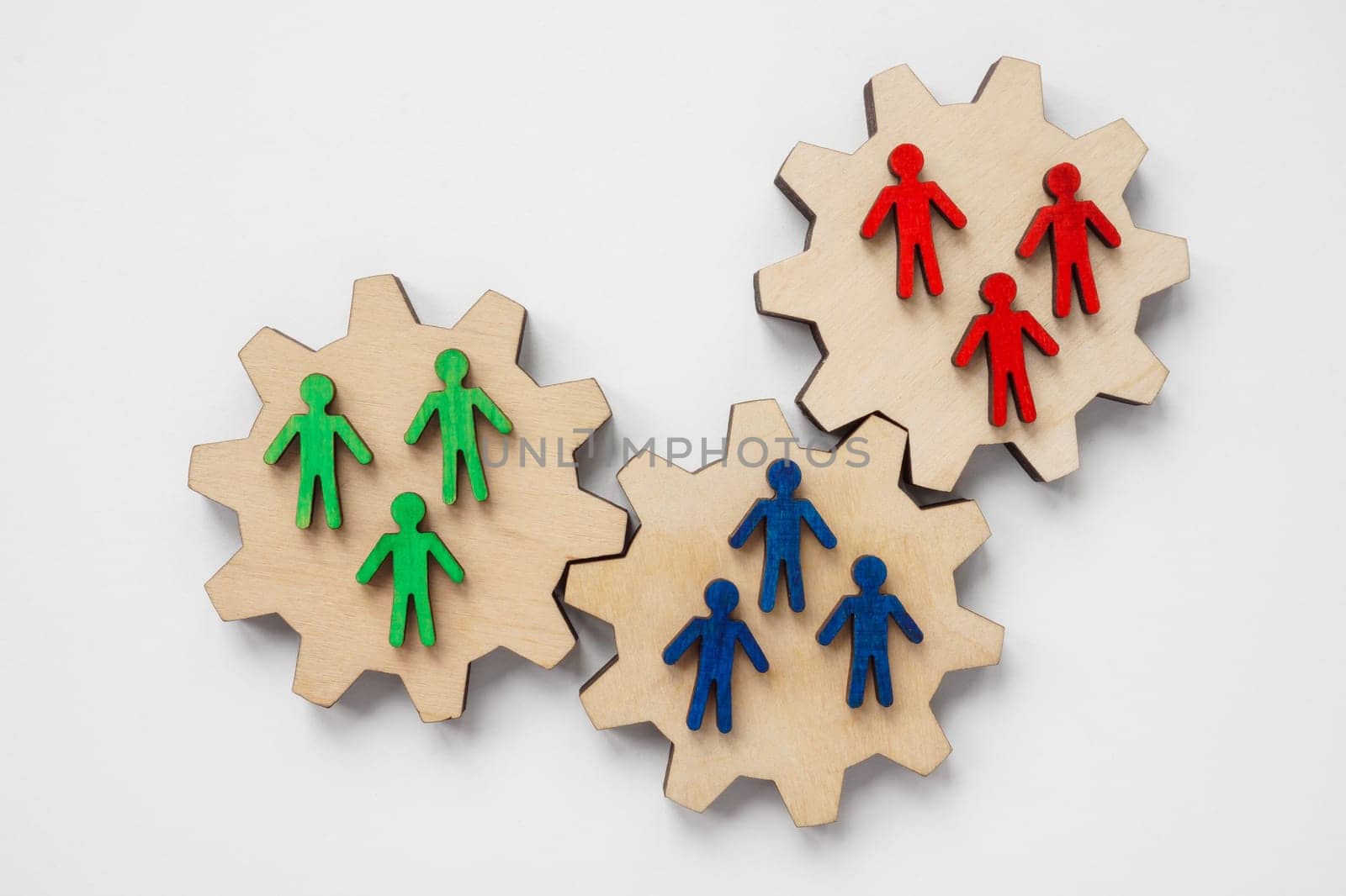 Wooden Gears and figures as a symbol of teamwork and collaboration.