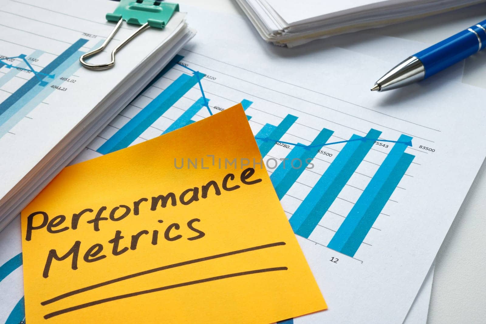 Stack of financial charts and performance metrics mark.