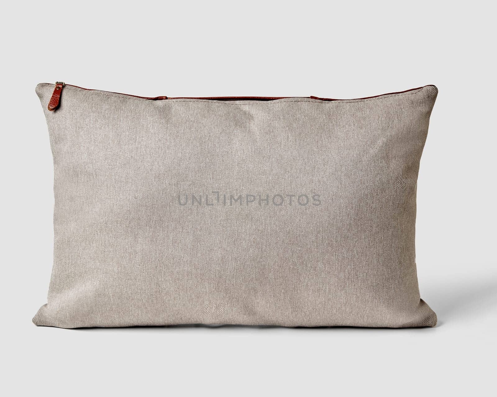 Natural textured grey fabric pillow featuring contrasting leather zipper, embodying modern and rustic home aesthetic. Handcrafted accessory for interior design