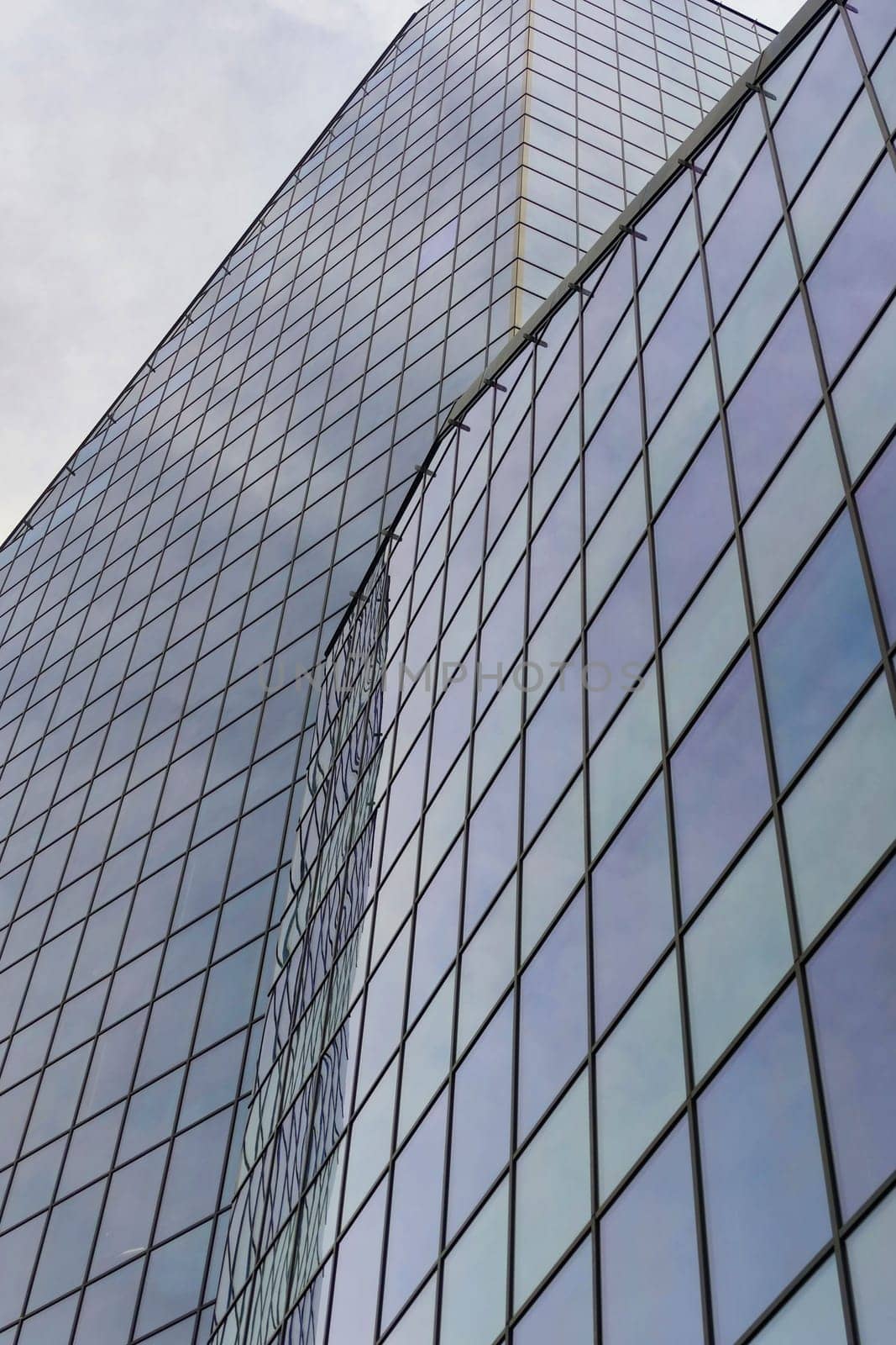 glass facade of skyscraper in perspective for vertical urban background.