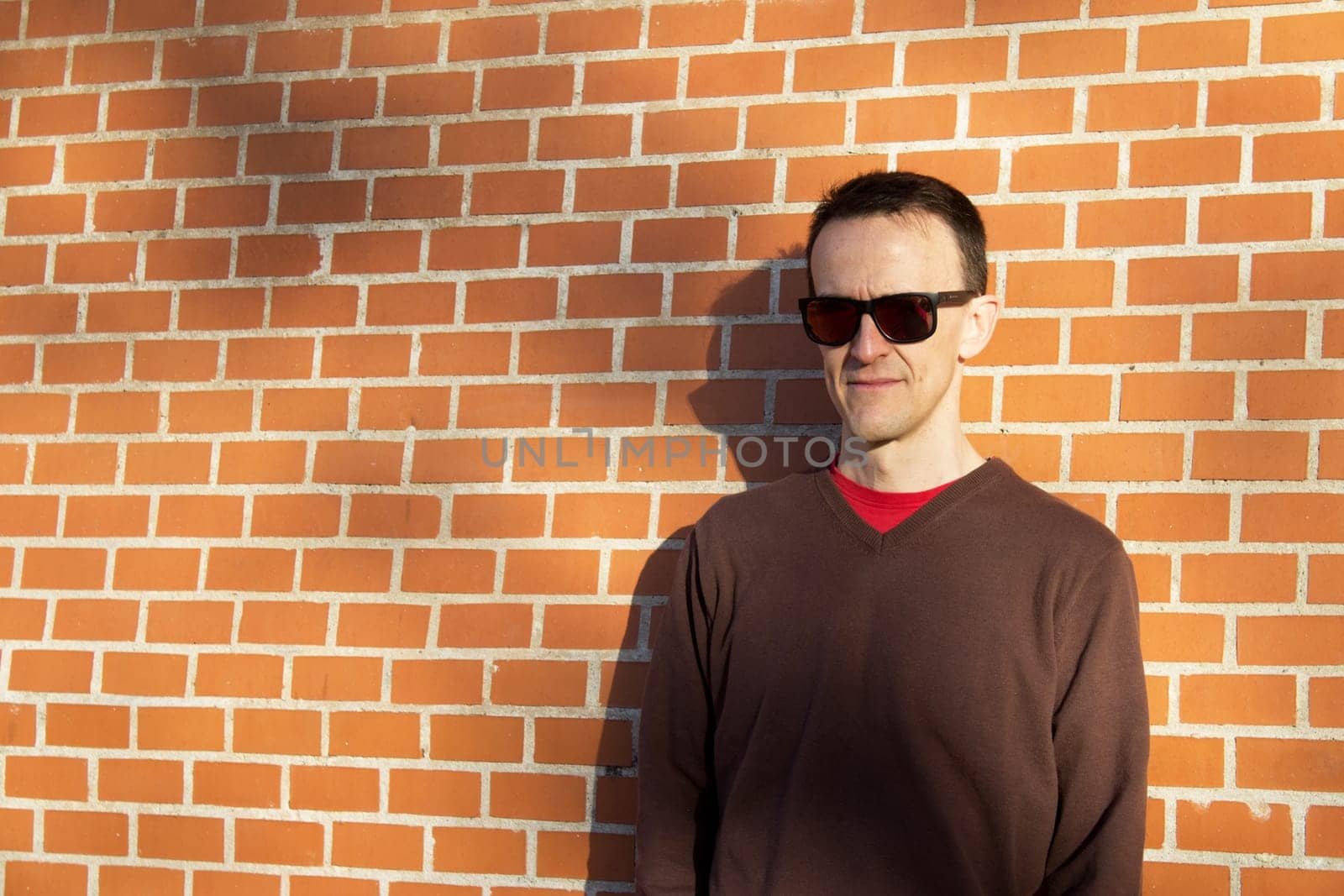 Jovial man in positive and calm attitude. Outside