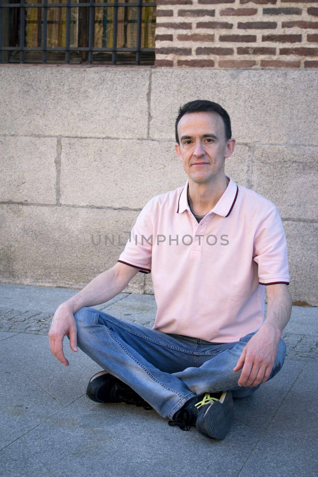 Jovial man in positive and calm attitude. Outside