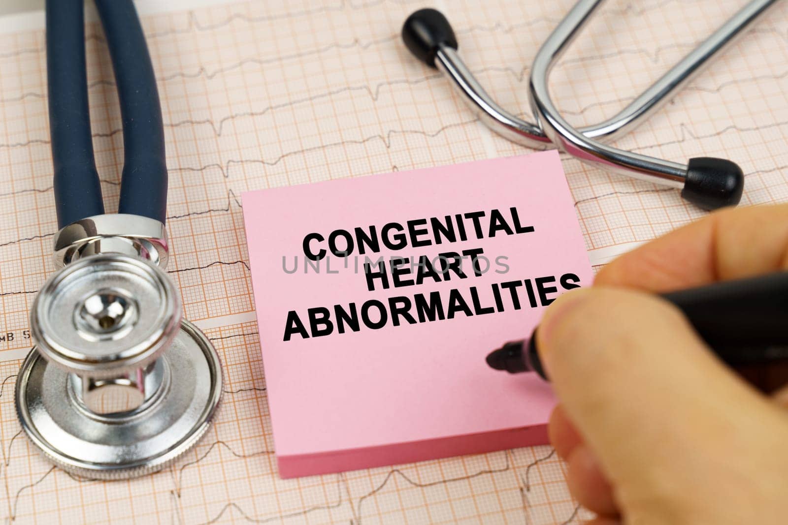 Medical concept. On the cardiograms there is a stethoscope and a sticker with the inscription - congenital heart abnormalities