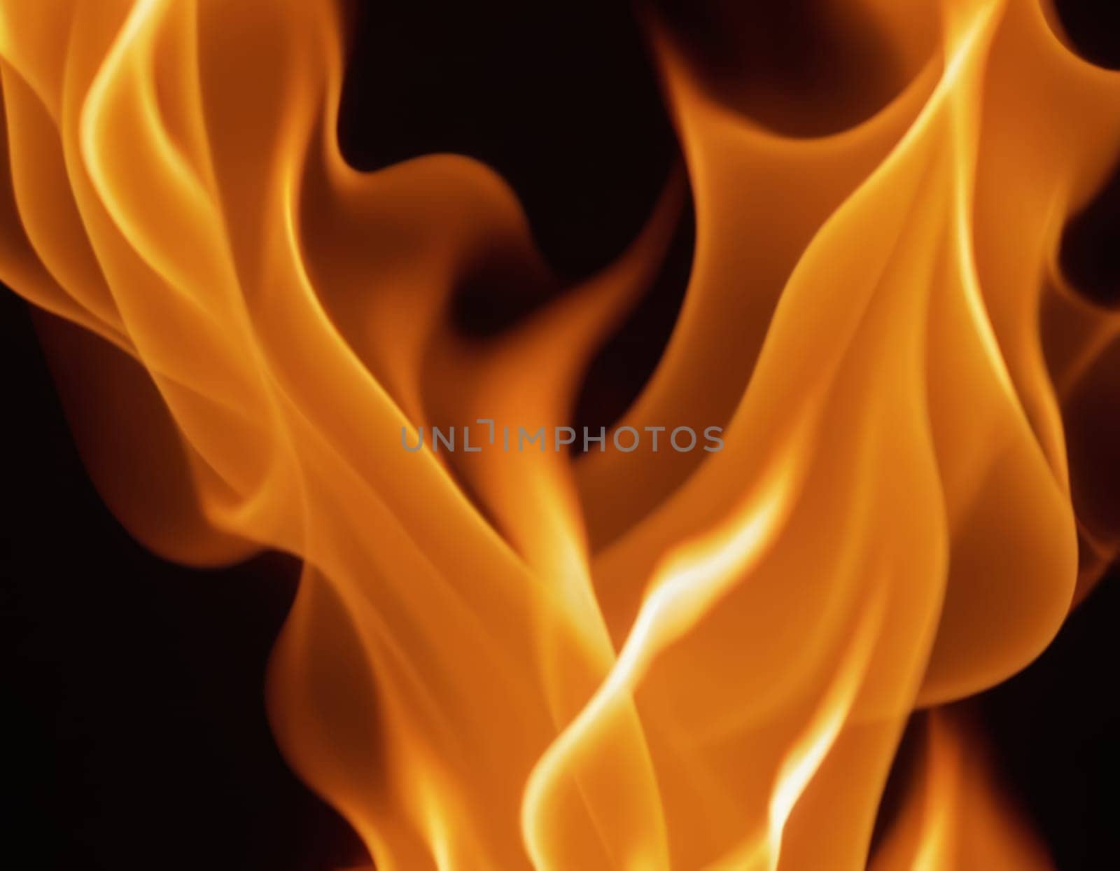 A close-up view of dynamic and intense flames in various shades of orange, yellow, and red, creating a contrast with the dark background and conveying a sense of heat and energy