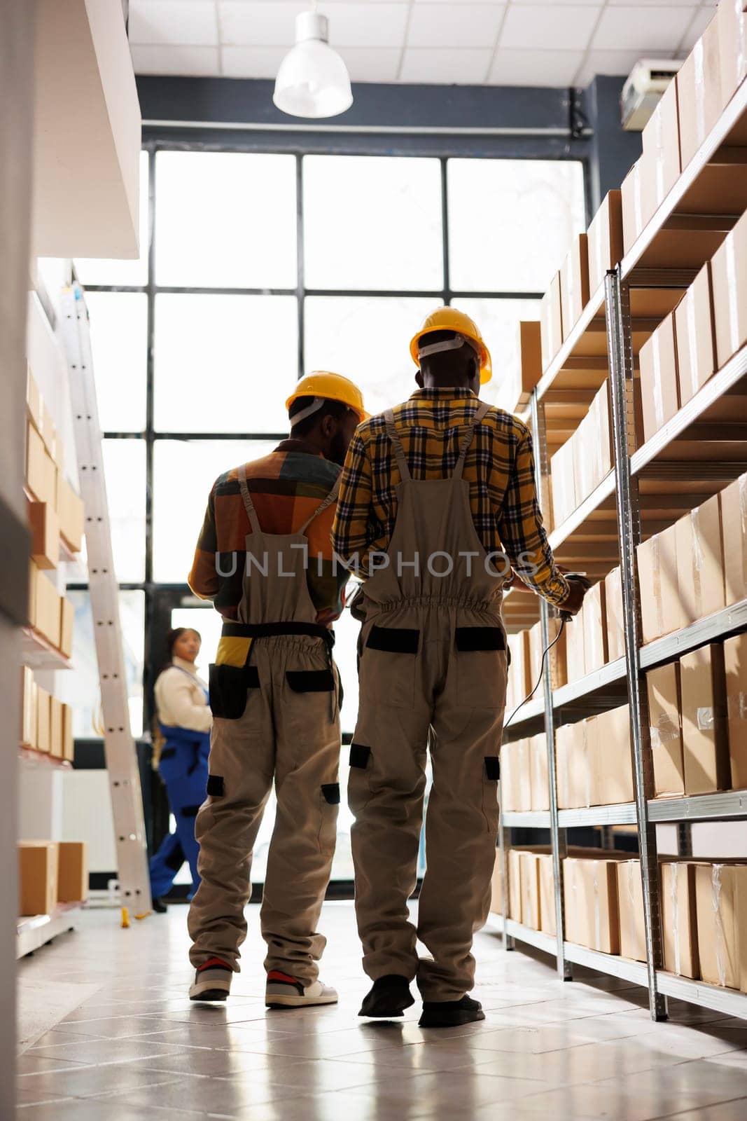 African american logistics managers scanning freight barcode before shipment. Factory distribution department operators managing cargo inventory using scanner in warehouse