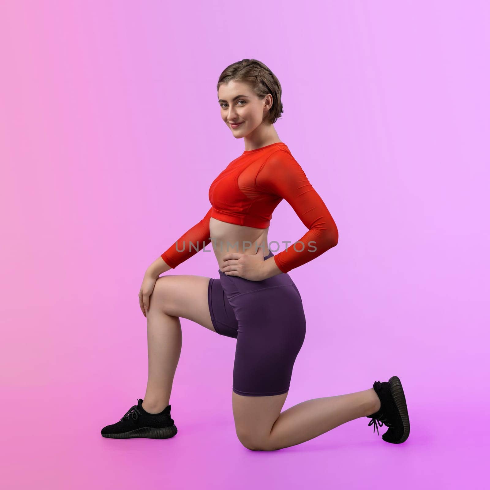 Full body length gaiety shot athletic and sporty young woman in fitness exercise posture on isolated background. Healthy active and body care lifestyle.