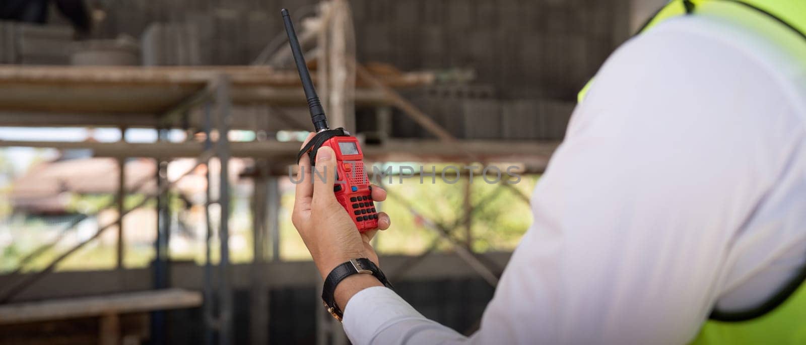 Engineer checking and inspection house project via walkie talkie before delivered to the homeowner. Concept of construction and inspection work.