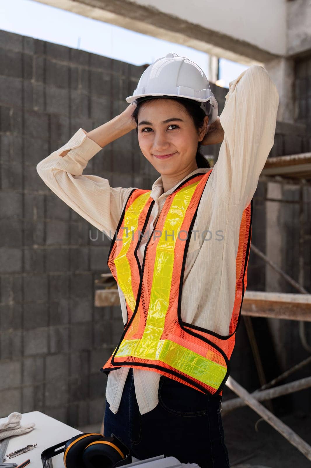 Female construction engineer. Architect with a blueprint at a construction site by nateemee