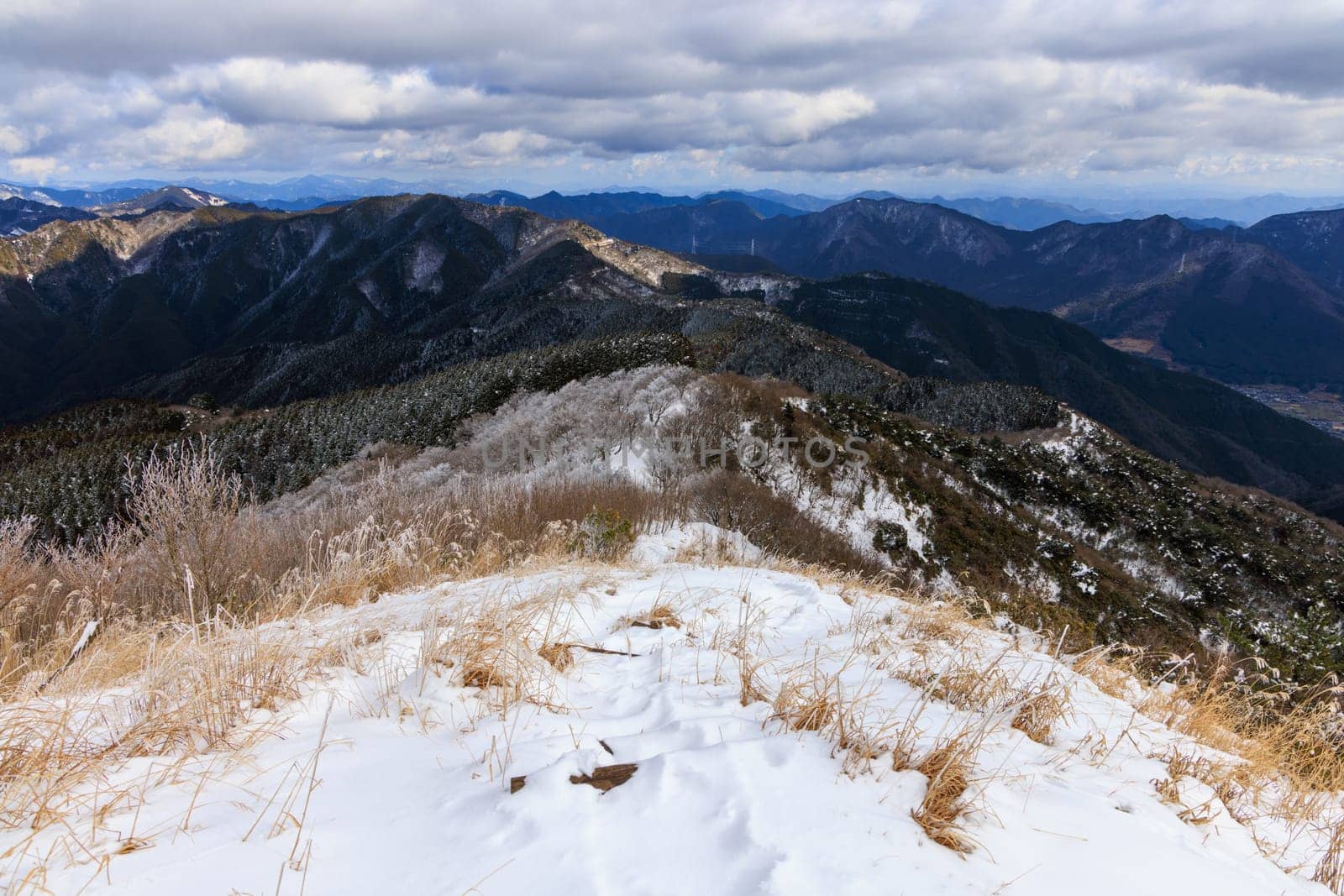 View from snow-covered mountain summit of beautiful winter landscape. High quality photo