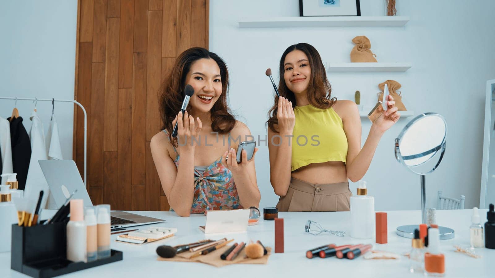 Two influencer partner shoot live streaming vlog video review makeup social media or blog. Happy young girl with vivancy cosmetics studio lighting for marketing recording session broadcasting online.