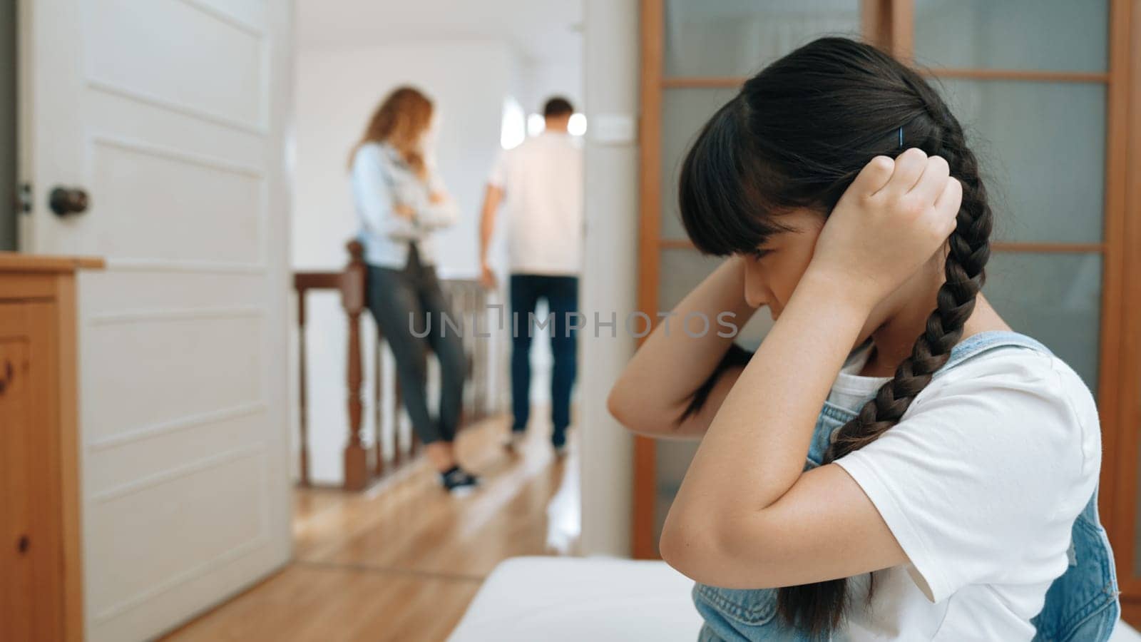 Stressed and unhappy young girl hide from domestic violence at home. Synchronos by biancoblue