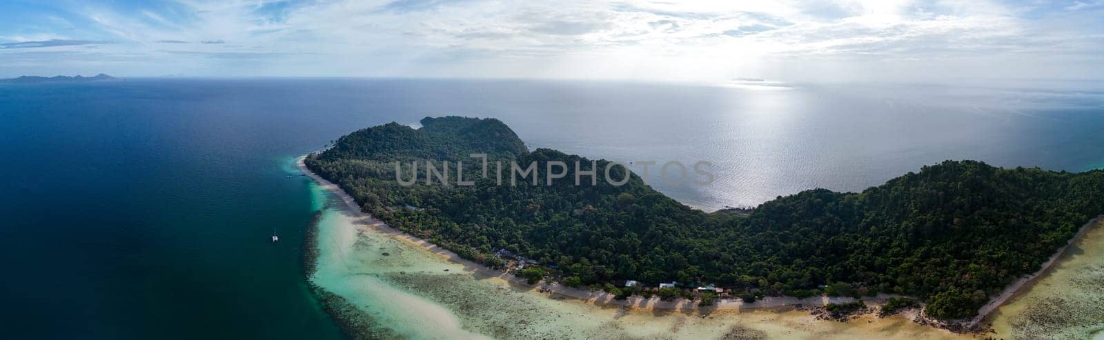 panoramic view Drone aerial view at Koh Kradan a tropical island with palm trees soft white sand, and a turqouse colored ocean in Koh Kradan Trang Thailand