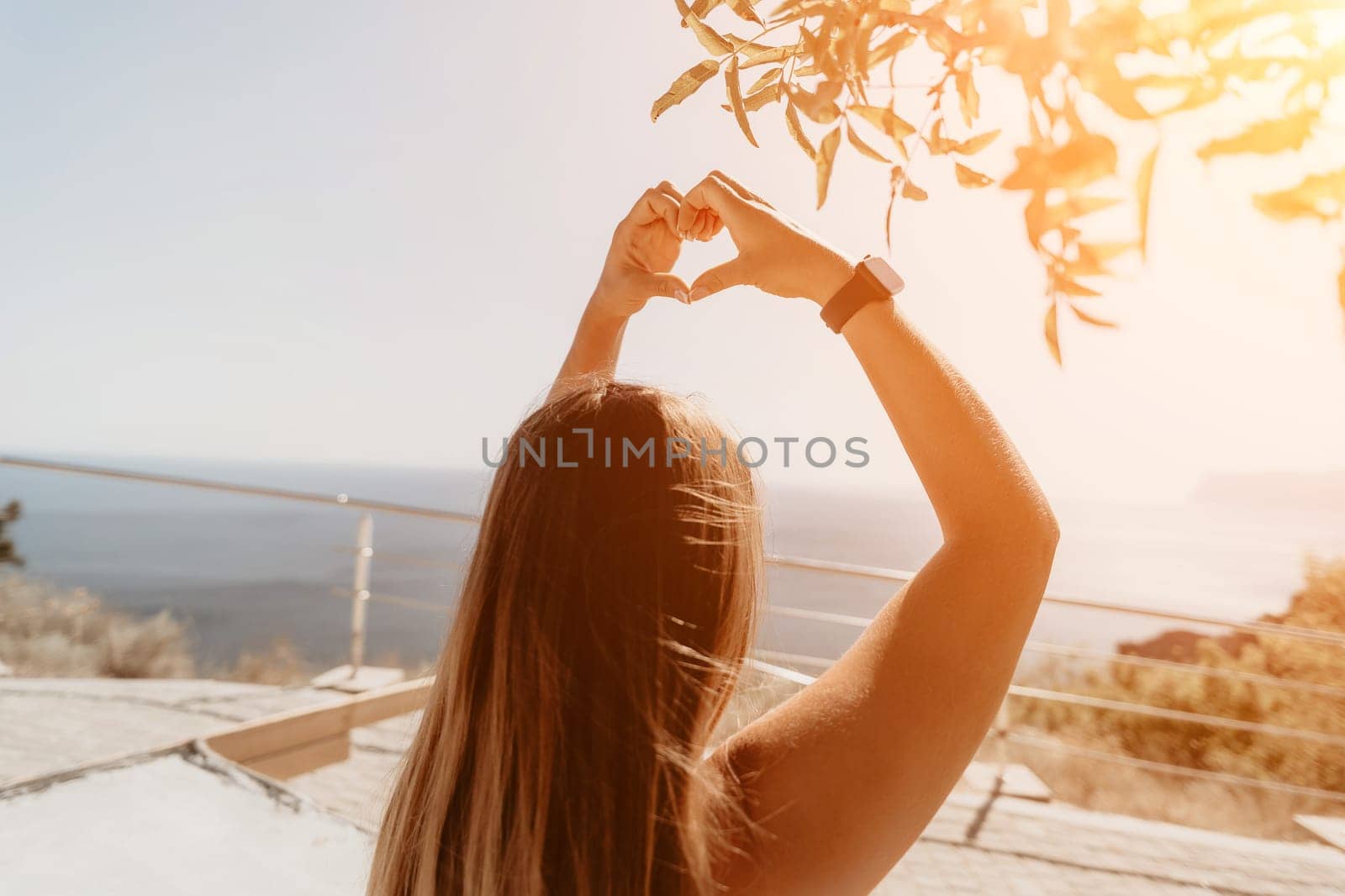 Fitness woman sea. Outdoor workout on yoga mat in park near to ocean beach. Female fitness pilates yoga routine concept. Healthy lifestyle. Happy fit woman exercising with rubber band in park.