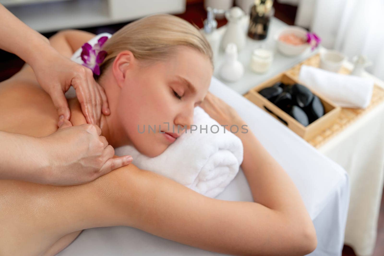 Caucasian woman customer enjoying relaxing anti-stress massage. Quiescent by biancoblue