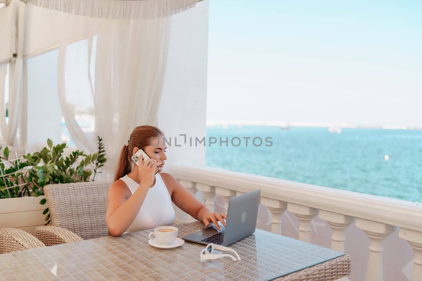 Woman coffee cafe laptop sea. Modern businessman in white uniform working on laptop in coffee shop. Woman sitting at a coffee shop with mobile phone drinking coffee
