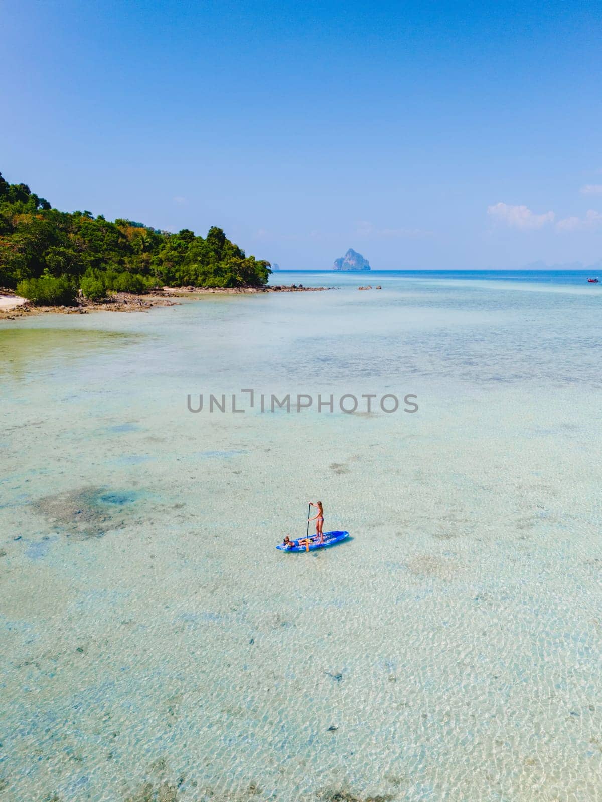 woman at peddle board sup at Koh Kradan a tropical island in Thailand by fokkebok