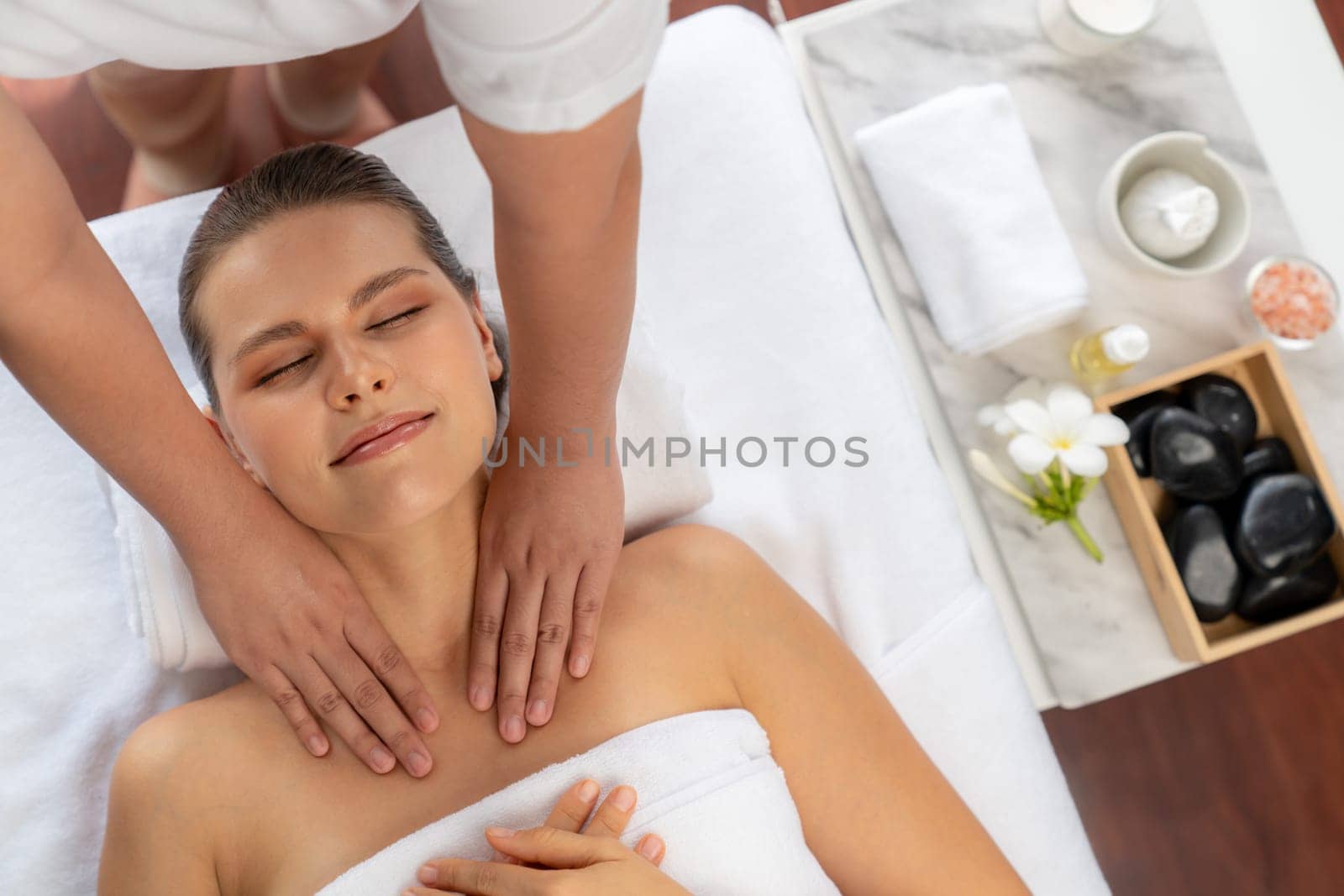 Caucasian woman customer enjoying relaxing anti-stress massage. Quiescent by biancoblue