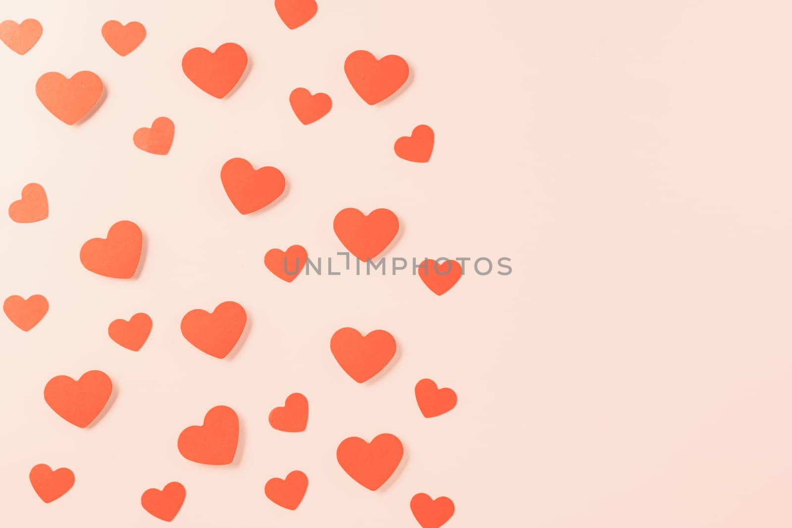 Happy Valentine's day concept. Symbol of love paper art with copy space for text, handmade red paper hearts shape cutting pastel pink background, Mother's Day