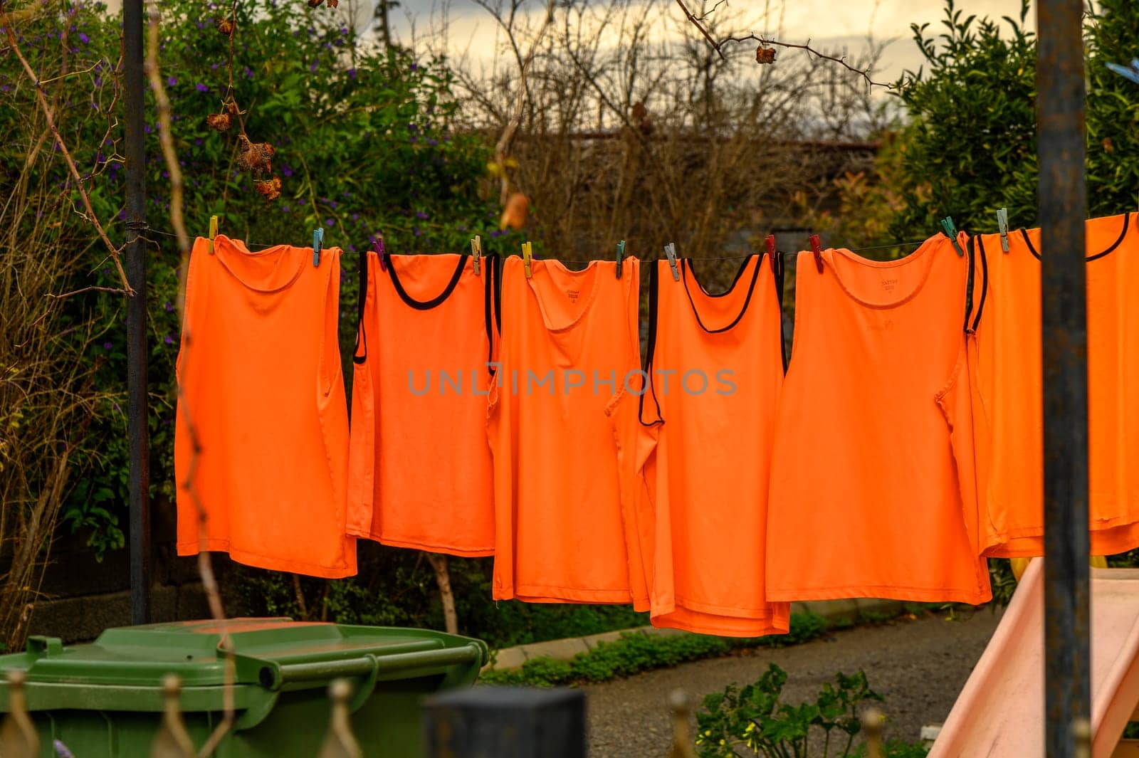 orange t-shirts drying on a line in winter in Cyprus 1