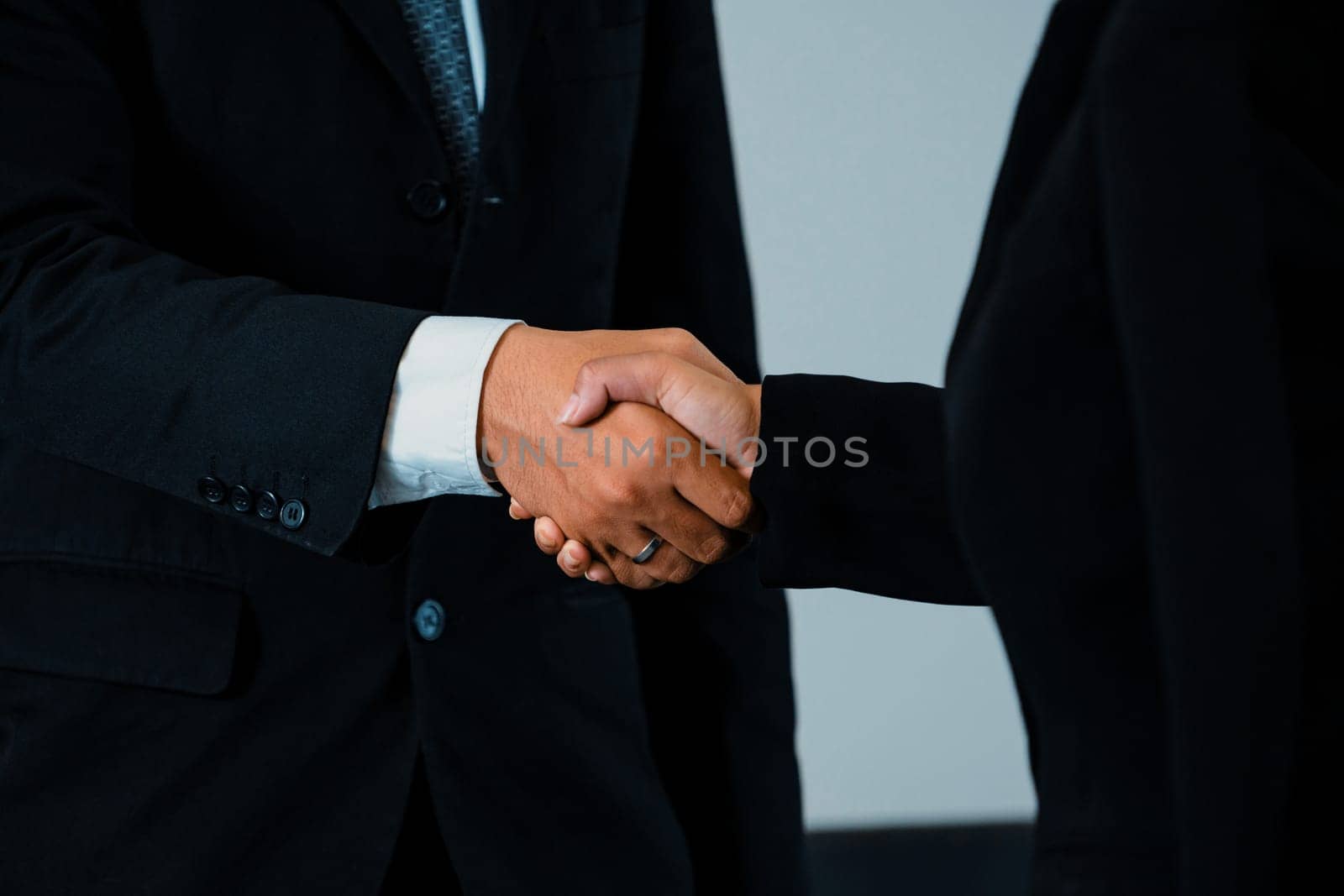 Business people handshake agreement in office. uds by biancoblue