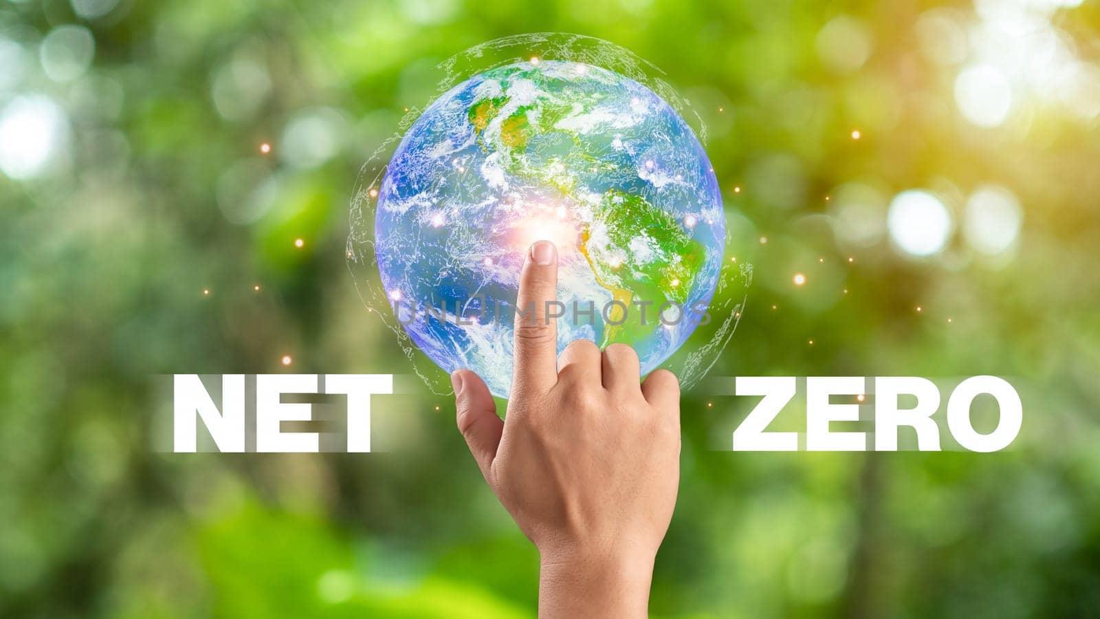 Hand of human pointing to earth and Net Zero icon, carbon neutral and net zero concept for net zero greenhouse gas emissions target, Climate neutral long term strategy, natural background.