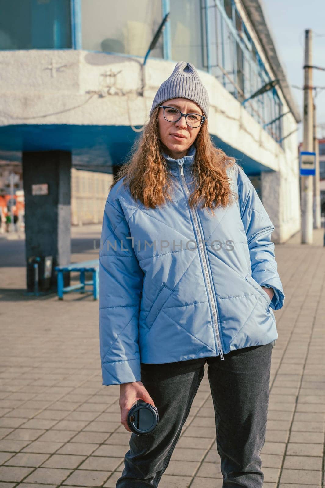 Portrait of a stylish woman in blue jacket. Spring outdoor portrait.