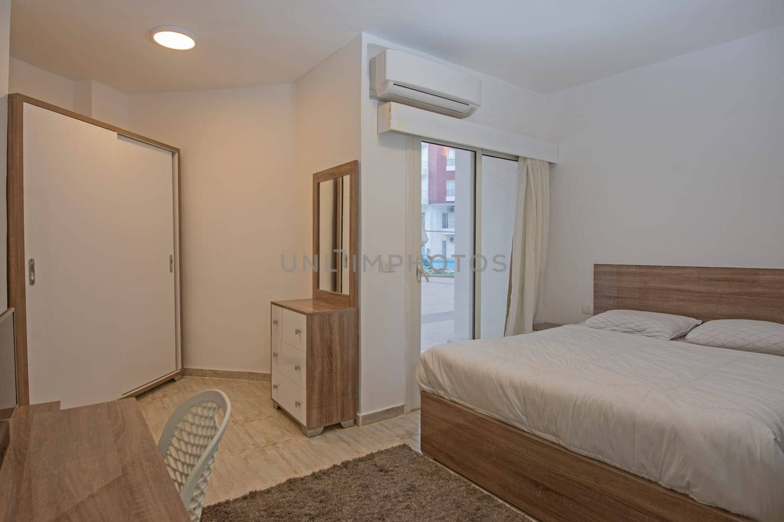 Interior design of bedroom in apartment with balcony by paulvinten