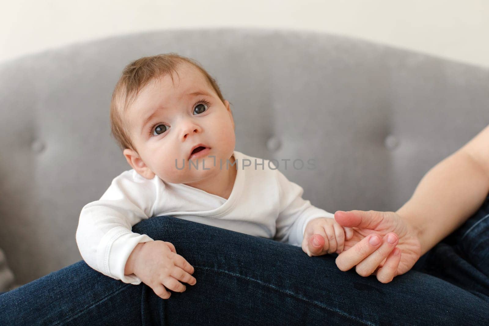 Adorable baby holding finger of person at home by Demkat